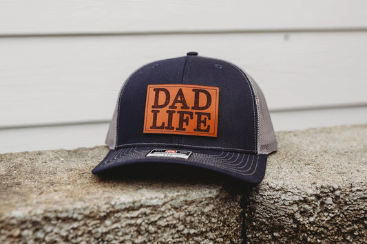 Dad Life Custom Leather Patch Hat - Crafthouse Hats leather patch hat company. Custom leather patch hats, also available in bulk or wholesale. Custom leather logo hats, custom leather hats, custom patch hats, leather logo hats, custom leather patches, custom logo leather hats, Richardson leather patch hats, Richardson 112 camo hats, yupoong camo trucker hats, leather hat patches, custom camo hats, leather hat, leather patch for hats, legacy hats, custom party hats, personalized camo hats, custom leather pat